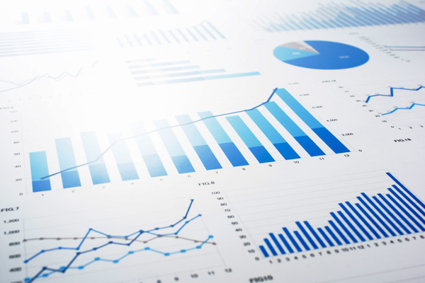 Many charts and graphs. Reflection light and flare. Concept image of data gathering and statistical working.